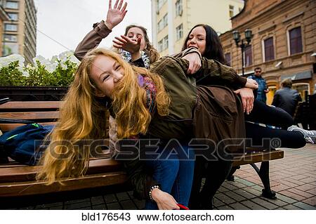 Caucasian women playing on bench View Large Photo Image Stock Image - Caucasian women playing on bench. Fotosearch