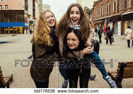 Stock Photograph - Caucasian women playing outdoors. Fotosearch
