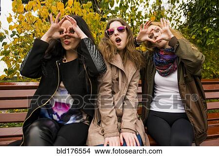 Picture - Caucasian women posing on bench. Fotosearch