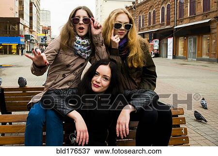 Caucasian women posing on bench View Large Photo Image Stock Photo - Caucasian women posing on bench. Fotosearch
