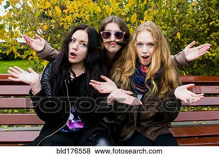 Caucasian women posing on bench View Large Photo Image Stock Photo - Caucasian women posing on bench. Fotosearch