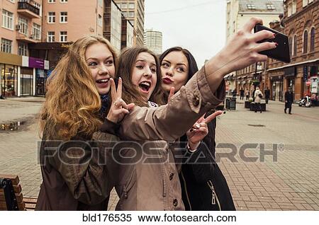 Caucasian women taking selfie outdoors View Large Photo Image Stock Photography - Caucasian women taking selfie outdoors. Fotosearch