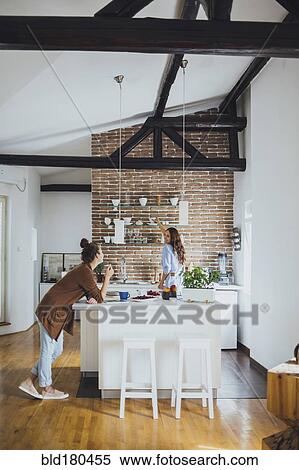 Caucasian women talking in kitchen View Large Photo Image Stock Photography - Caucasian women talking in kitchen. Fotosearch