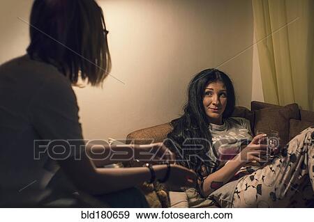 Caucasian women talking in living room View Large Photo Image Stock Photo - Caucasian women talking in living room. Fotosearch