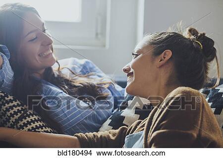 Picture - Caucasian women talking on sofa. Fotosearch