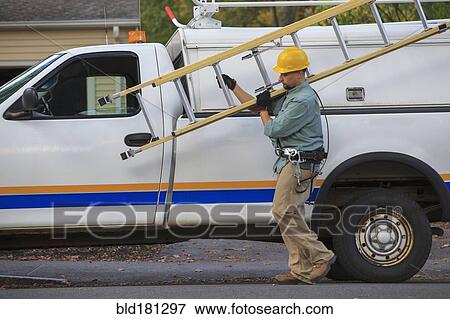 Caucasian worker carrying ladder near truck View Large Photo Image Stock Photo - Caucasian worker carrying ladder near truck. Fotosearch