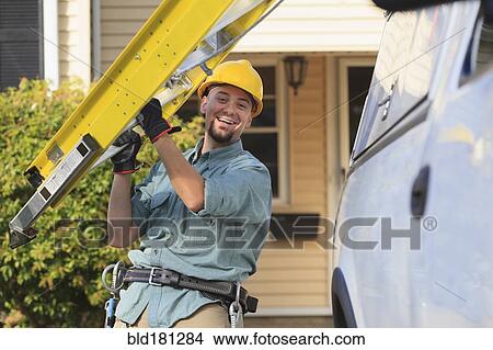 Picture - Caucasian worker carrying ladder. Fotosearch