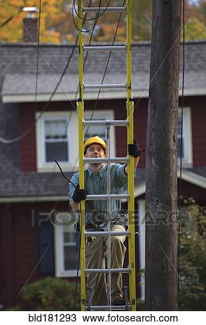 Caucasian worker climbing ladder View Large Photo Image Stock Image - Caucasian worker climbing ladder. Fotosearch