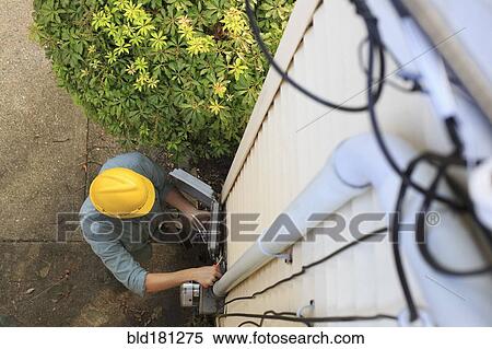 Caucasian worker installing cable box View Large Photo Image Stock Photography - Caucasian worker installing cable box. Fotosearch