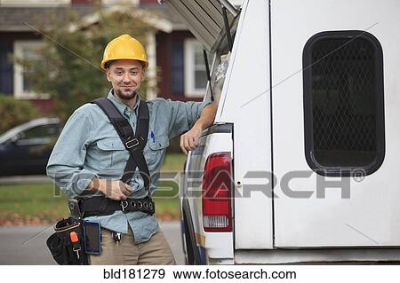 Caucasian worker smiling at truck View Large Photo Image Stock Photo - Caucasian worker smiling at truck. Fotosearch