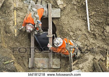 Caucasian workers building at construction site View Large Photo Image Stock Photo - Caucasian workers building at construction site. Fotosearch
