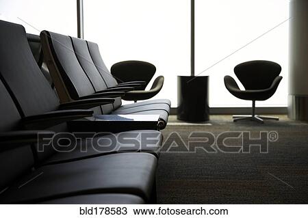 Stock Image - Chairs in airport waiting area. Fotosearch