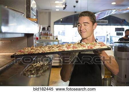 Stock Photography - Chef cooking food in restaurant kitchen. Fotosearch