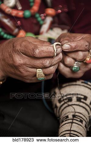 Stock Image - Close up of artist making traditional jewelry. Fotosearch