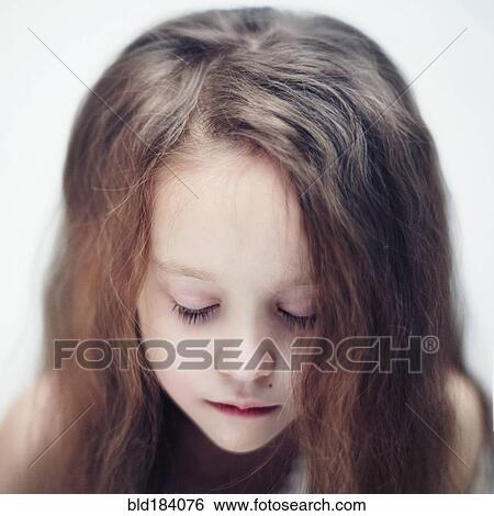 Stock Photograph - Close up of Caucasian girl with eyes closed. Fotosearch