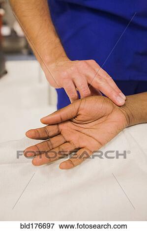 Close up of doctor checking pulse of patient View Large Photo Image Stock Photo - Close up of doctor checking pulse of patient. Fotosearch