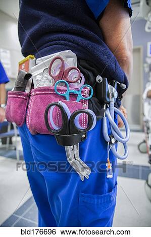 Close up of doctor wearing tool belt in hospital View Large Photo Image Stock Photograph - Close up of doctor wearing tool belt in hospital. Fotosearch