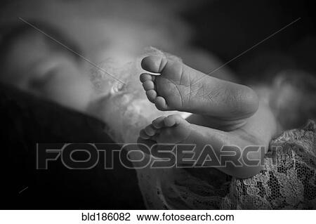 Stock Image - Close up of feet of sleeping baby. Fotosearch