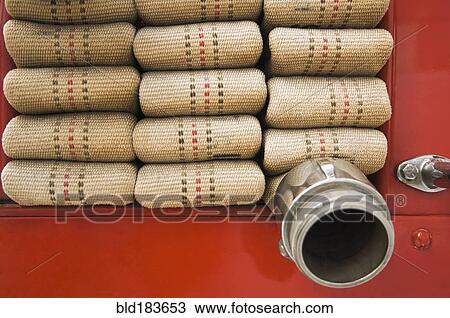 Stock Image - Close up of folded fire hose. Fotosearch
