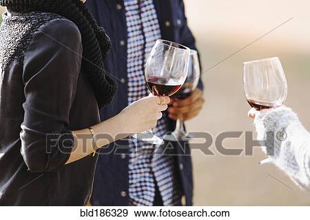 Close up of friends drinking wine View Large Photo Image Stock Photo - Close up of friends drinking wine. Fotosearch