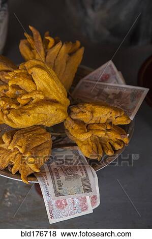 Close up of fruit and money in shrine View Large Photo Image Stock Photo - Close up of fruit and money in shrine. Fotosearch