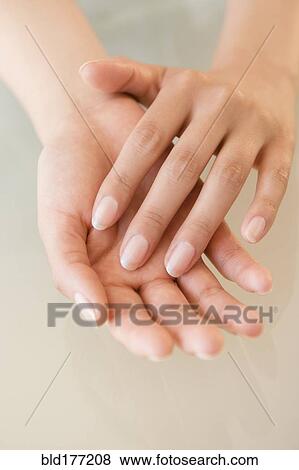 Stock Photo - Close up of hands of Hispanic woman. Fotosearch