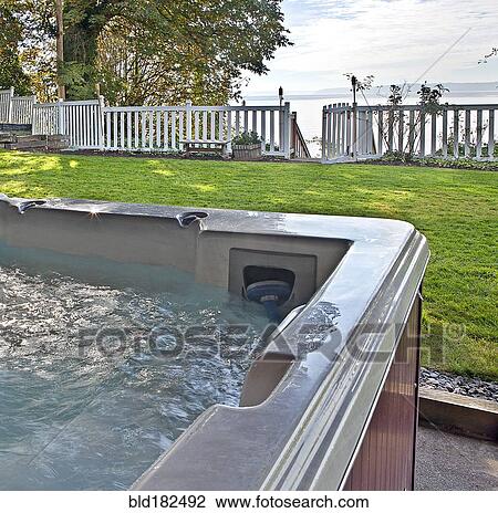 Close up of hot tub in backyard View Large Photo Image Stock Image - Close up of hot tub in backyard. Fotosearch