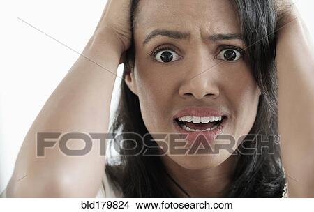 Picture - Close up of mixed race woman gasping. Fotosearch
