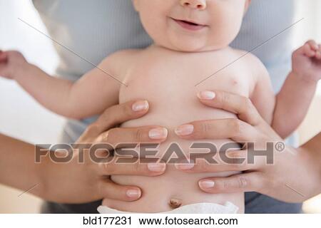 Close up of mother holding baby View Large Photo Image Stock Image - Close up of mother holding baby. Fotosearch