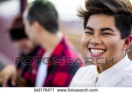 Stock Image - Close up of woman laughing outdoors. Fotosearch