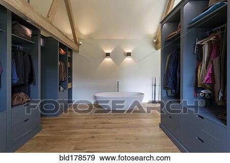Closet and bathtub in modern bedroom View Large Photo Image Stock Photo - Closet and bathtub in modern bedroom. Fotosearch