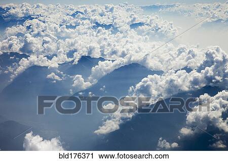 Clouds over remote mountaintops View Large Photo Image Stock Image - Clouds over remote mountaintops. Fotosearch