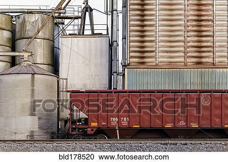 Stock Image - Container on train tracks in industrial train yard. Fotosearch