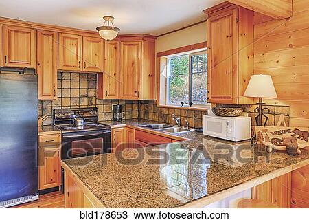 Stock Image - Countertops and cabinets in rustic kitchen. Fotosearch