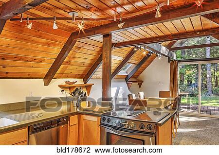 Stock Image - Countertops and dining area in rustic kitchen. Fotosearch