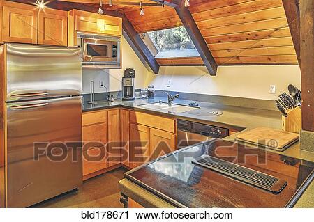 Stock Image - Countertops and refrigerator in rustic kitchen. Fotosearch