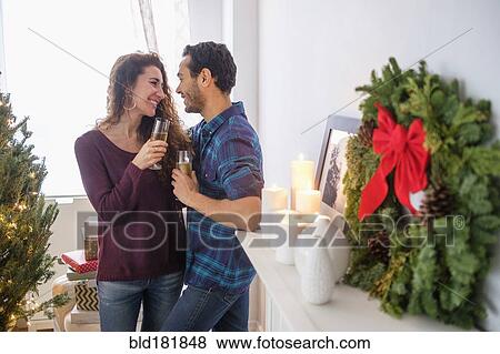 Stock Photo - Couple drinking champagne at Christmas. Fotosearch