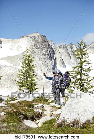 Stock Image - Couple hiking in remote mountains. Fotosearch