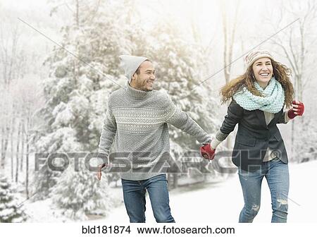 Couple holding hands in snow View Large Photo Image Picture - Couple holding hands in snow. Fotosearch