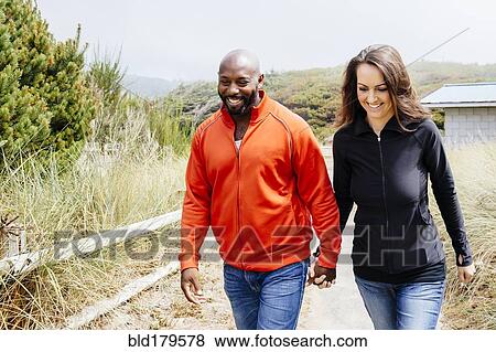 Couple holding hands on beach View Large Photo Image Stock Photo - Couple holding hands on beach. Fotosearch