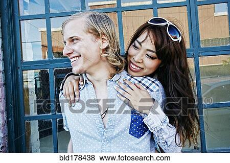 Stock Photo - Couple hugging at window. Fotosearch