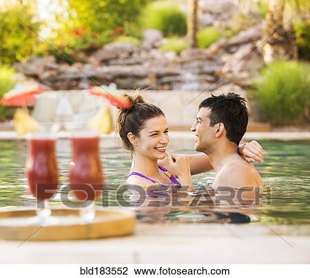 Couple hugging in swimming pool View Large Photo Image Stock Image - Couple hugging in swimming pool. Fotosearch