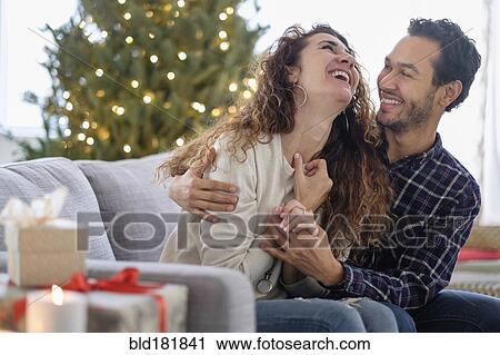 Couple hugging on sofa View Large Photo Image Stock Image - Couple hugging on sofa. Fotosearch