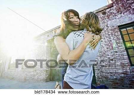 Picture - Couple hugging outdoors. Fotosearch