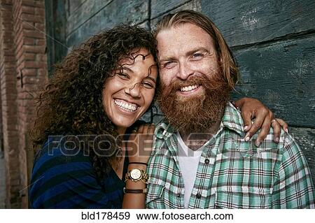 Stock Photo - Couple hugging outdoors. Fotosearch