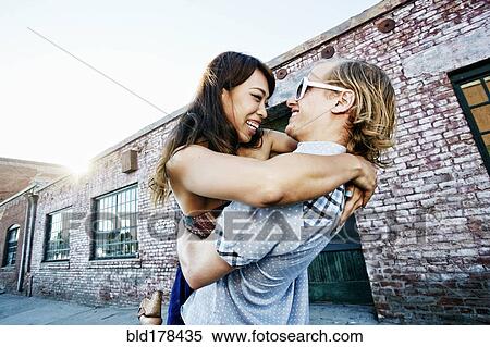 Stock Photography - Couple hugging outdoors. Fotosearch