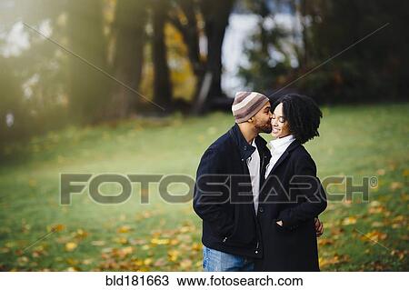 Couple kissing in park View Large Photo Image Stock Image - Couple kissing in park. Fotosearch