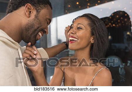 Couple laughing outdoors View Large Photo Image Stock Photograph - Couple laughing outdoors. Fotosearch