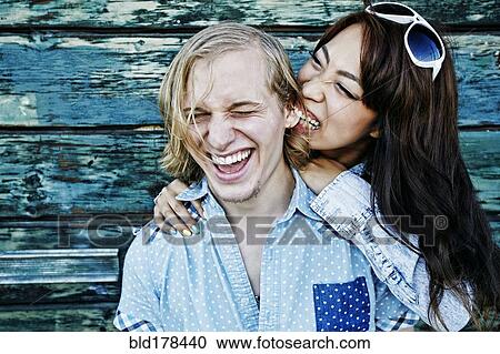 Stock Image - Couple playing at wooden wall. Fotosearch