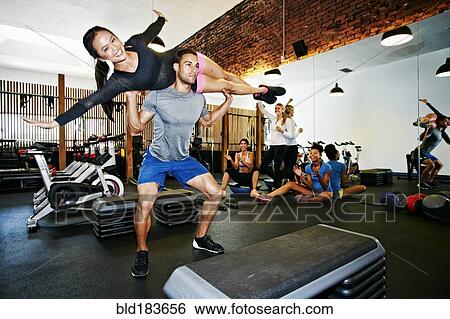 Couple working out in gymnasium View Large Photo Image Stock Photograph - Couple working out in gymnasium. Fotosearch